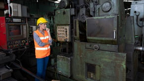 woman reviewing broken-down equipment to develop a maintenance strategy