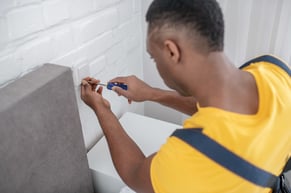 a worker preparing to perform routine maintenance in a restroom