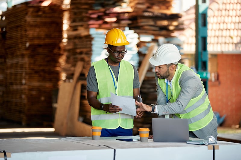 operations manager and technician looking over a preventive maintenance task and related manual