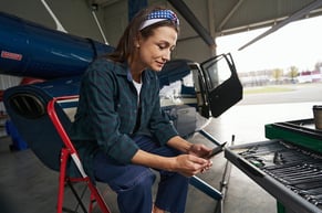 maintenance worker analyzing successful implementation of a cmms on a mobile device