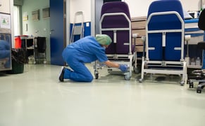 worker in hospital fixing a machine before failure occurs