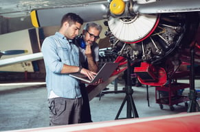 maintenance managers discussing preventive maintenance and predictive maintenance using a computerized maintenance management system